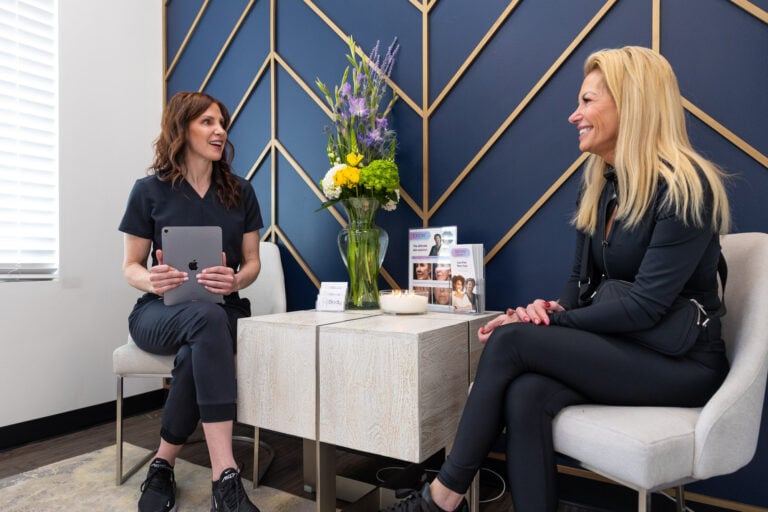 A Frisco Body Contouring provider is sitting down in for a consultation with a patient to discuss Ultra hair restoration in Frisco, TX.